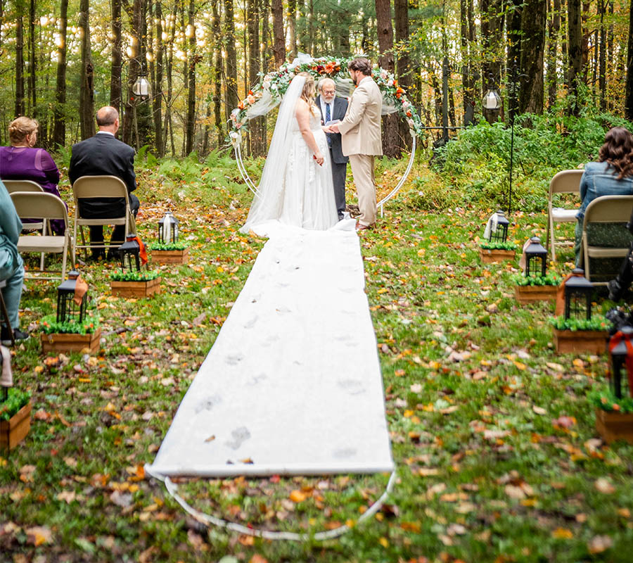 outdoor wedding with white aisle runner
