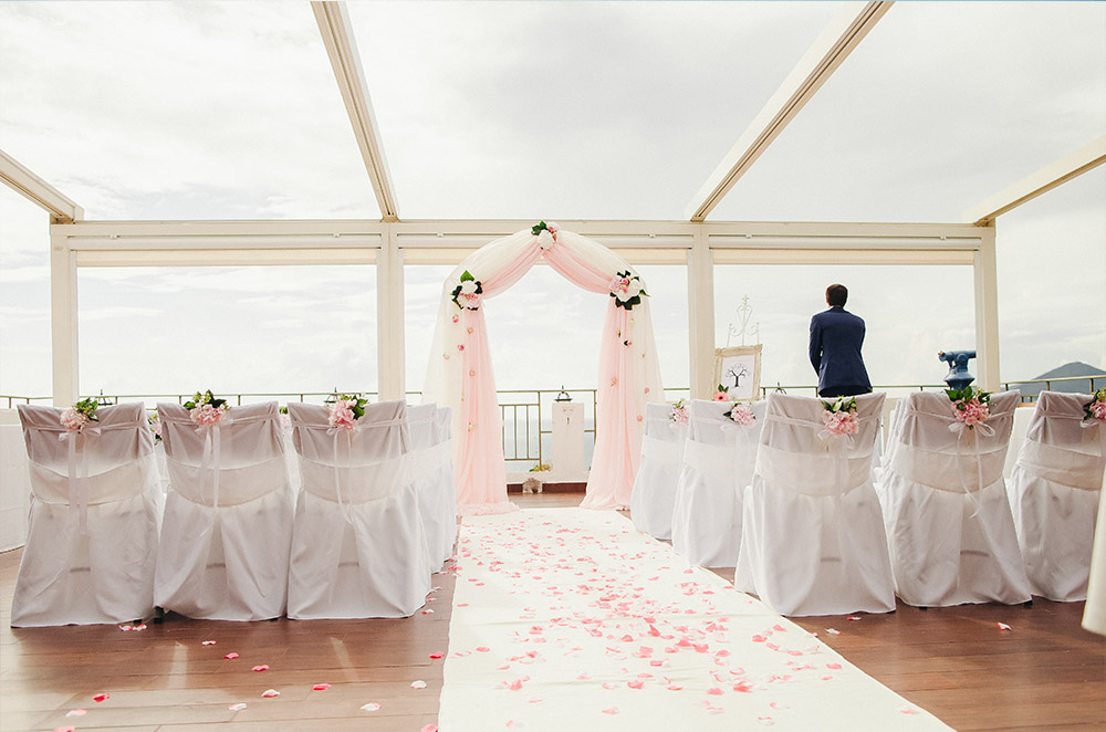 White and pink wedding ceremony with flower petals