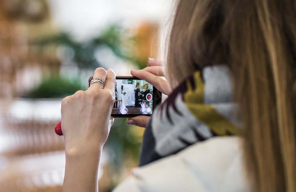 guest videographer filming on phone